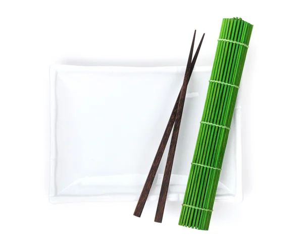 Empty plate, chopsticks and mat — Stock Photo, Image