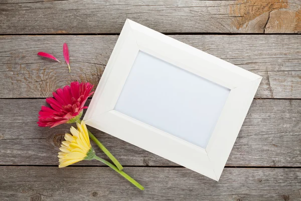 Two  gerbera flowers and photo frame — Stock Photo, Image