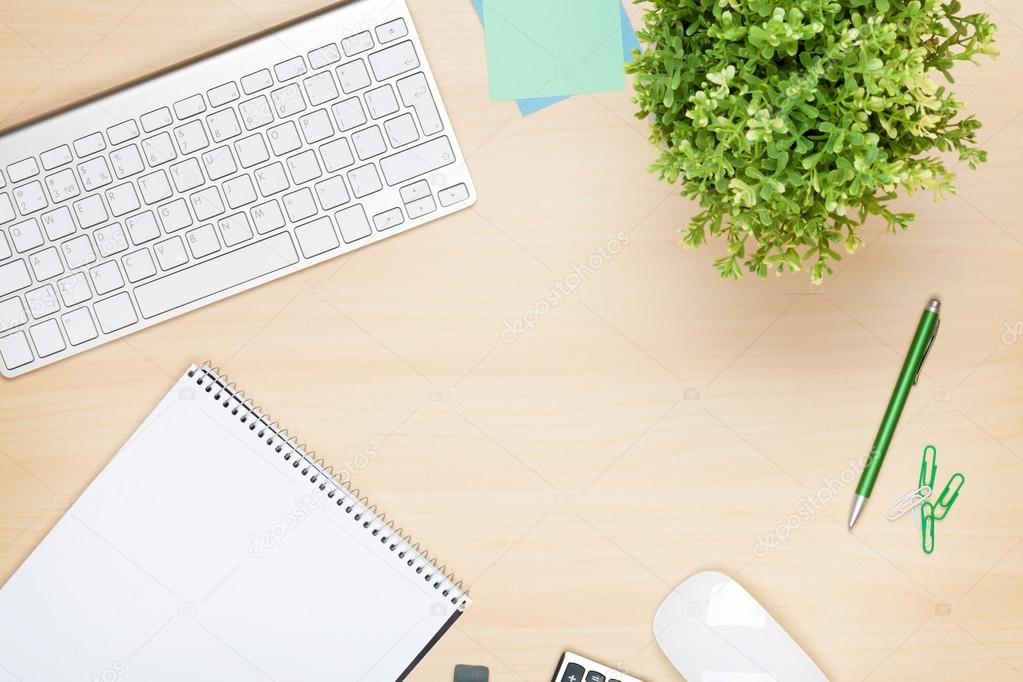 Office table with notepad, computer