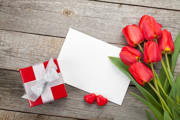 Fresh tulips, gift box and greeting card — Stock Photo, Image