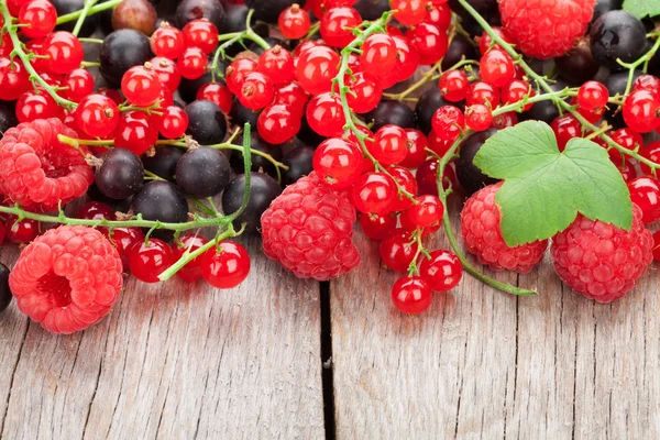 Fresh ripe berries on wooden table — Stock Photo, Image