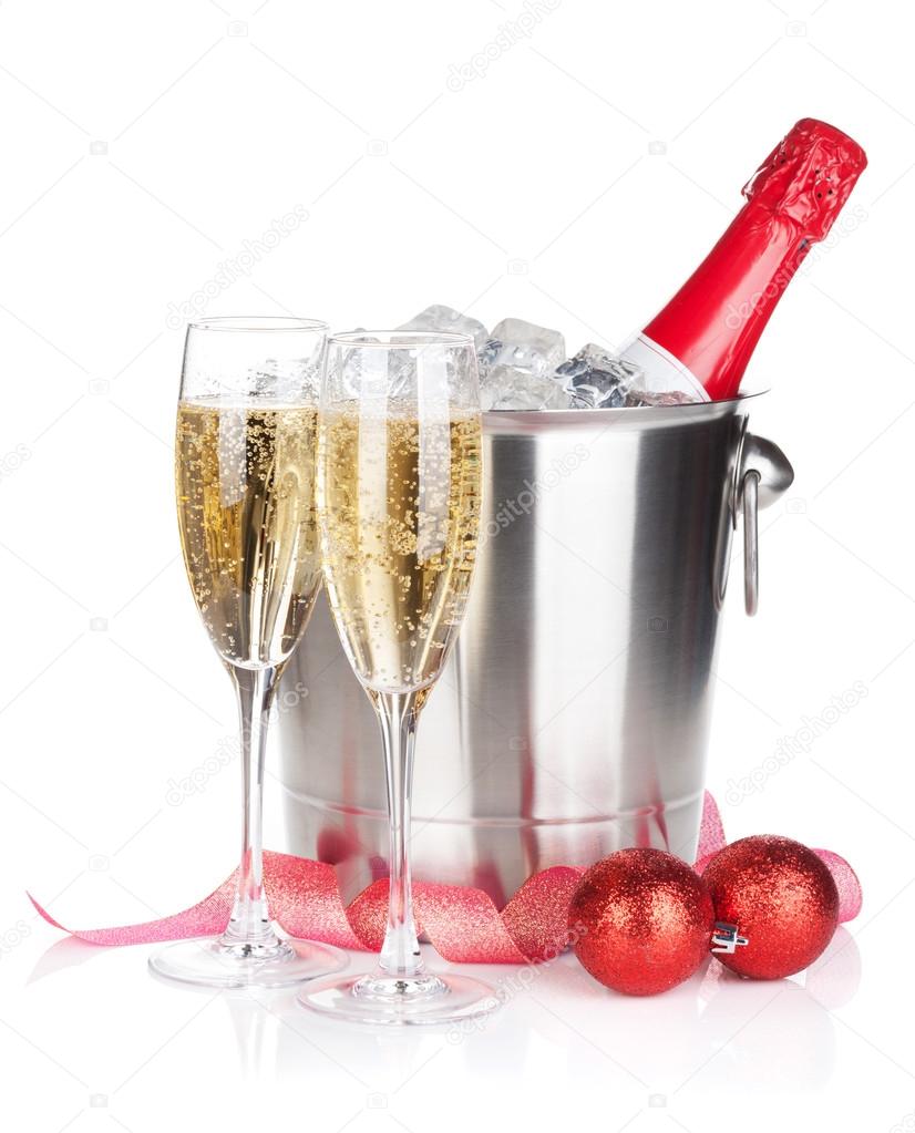 Champagne bottle in ice bucket, two glasses