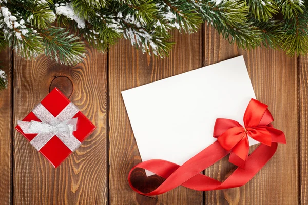 Christmas gift box and blank greeting card — Stock Photo, Image
