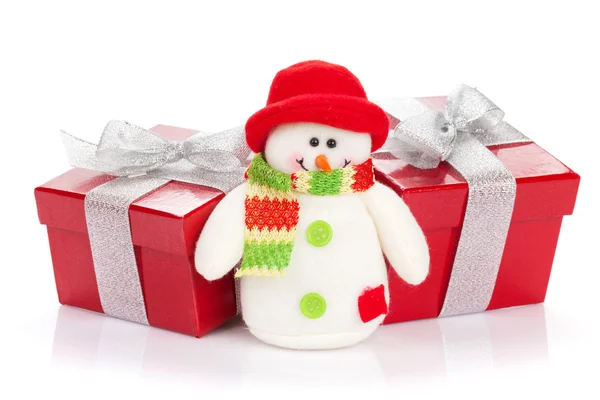 Christmas gift boxes and snowman toy — Stock Photo, Image