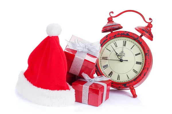 Christmas clock, gifts and santa hat — Stock Photo, Image