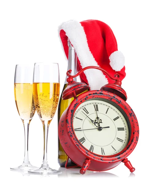 Verres à champagne, chapeau de Père Noël, bouteille et horloge — Photo