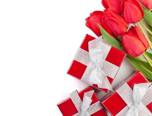 Fresh red tulips with gift boxes — Stock Photo, Image