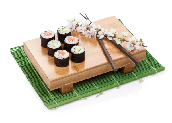 Sushi maki set with salmon and cucumber and sakura branch — Stock Photo, Image