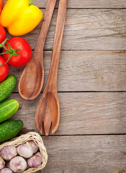 Fresh ripe vegetables and utensils on wooden table — Stock Photo, Image