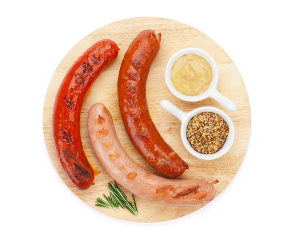 Various grilled sausages with condiments — Stock Photo, Image