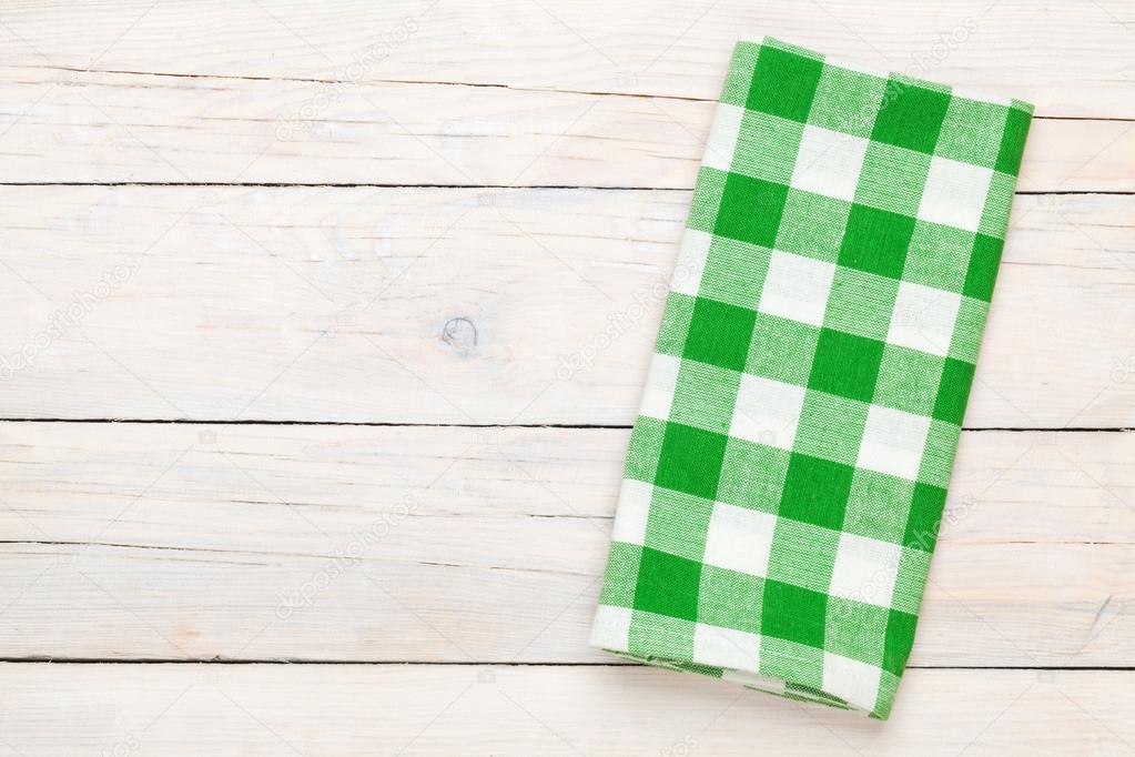 Green towel over wooden kitchen table