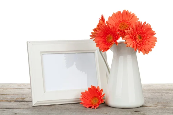 Orange gerbera flowers and photo frame — Stock Photo, Image