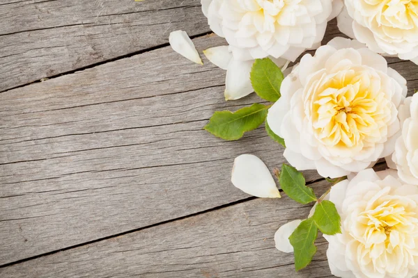 Holzhintergrund mit frischen Rosenblüten — Stockfoto