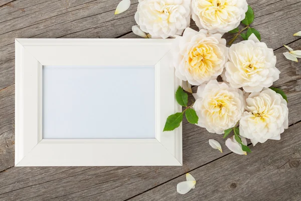Prázdné foto rámeček a bílé růže — Stock fotografie