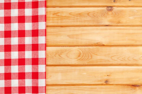 Red towel over wooden kitchen table — Stock Photo, Image