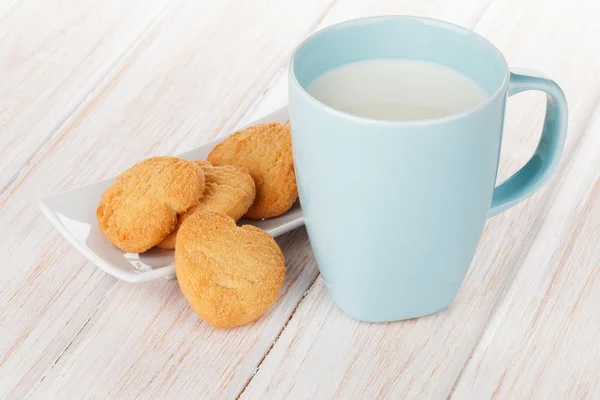 Cup of milk and heart shaped cookies — Stock Photo, Image