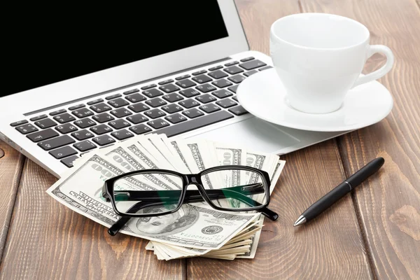 Office table with pc, coffee cup, glasses and money — Stock Photo, Image