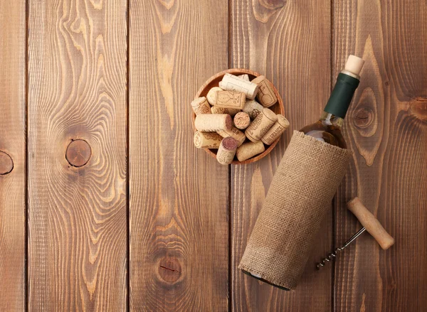 White wine bottle, bowl with corks and corkscrew — Stock Photo, Image