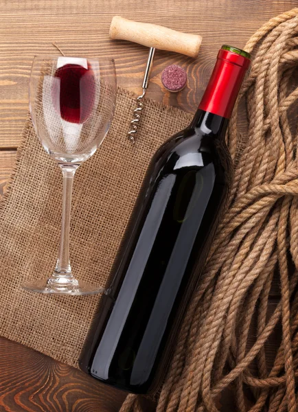 Red wine bottle, glass, cork and corkscrew — Stock Photo, Image