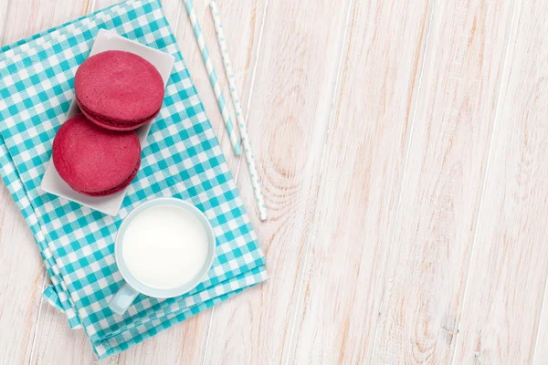 Colorful macarons and cup of milk — Stock Photo, Image