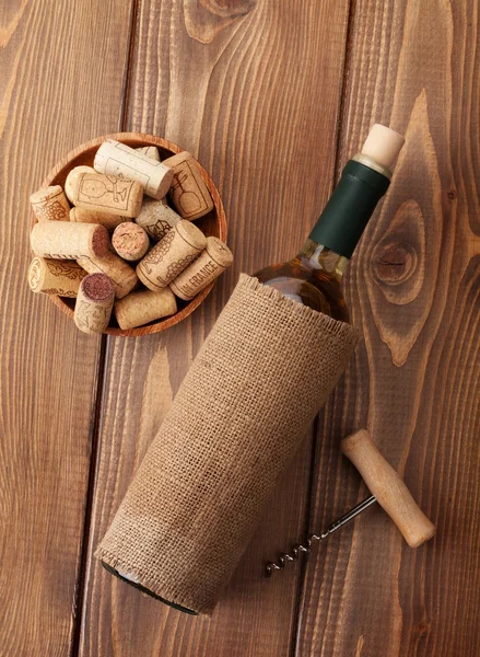 White wine bottle, corks and corkscrew — Stock Photo, Image