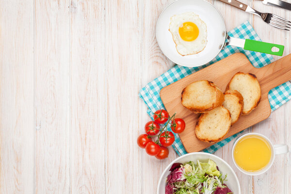 Здоровый завтрак с яичницей, тостами и салатом
