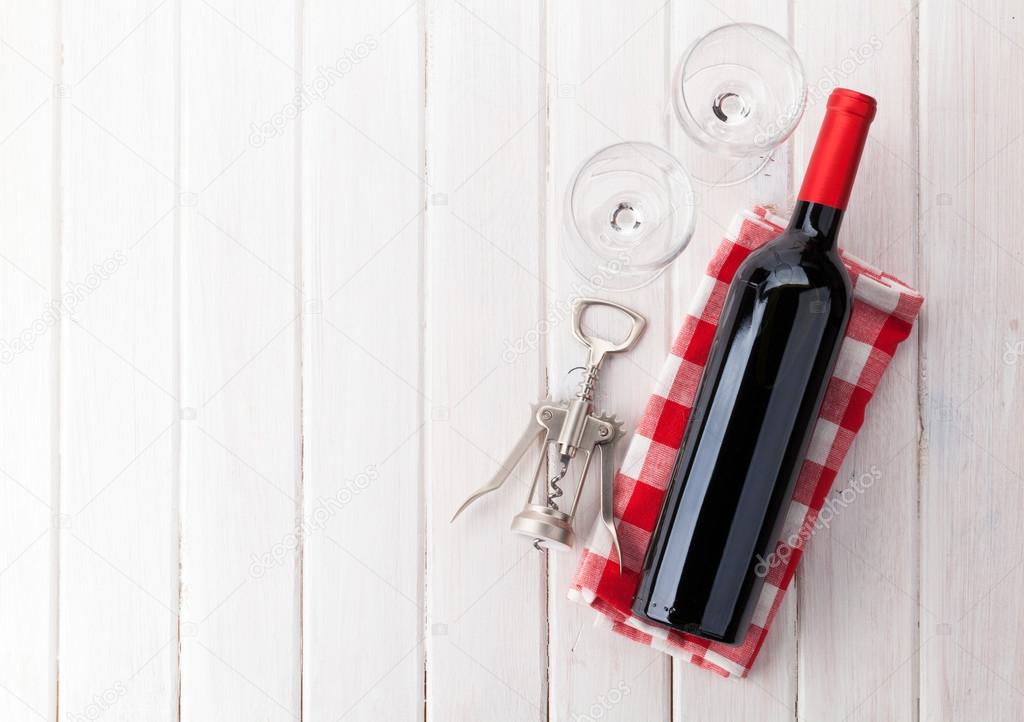 Red wine bottle, glasses and corkscrew