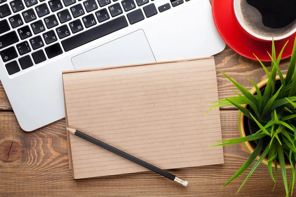 Office desk table with computer, supplies, coffee cup and flower — Stock Photo, Image