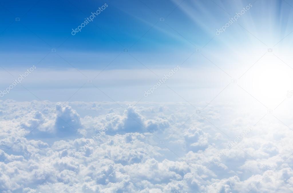 Blue sky with clouds and sun