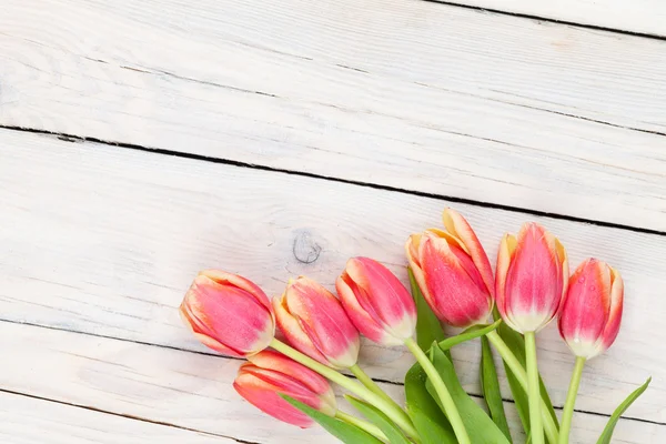 Colorful tulips on wooden table — Stock Photo, Image