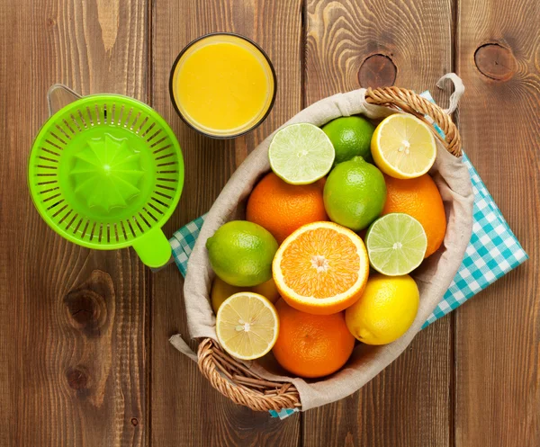 Citrus fruits and glass of juice.