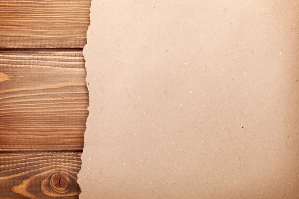 Karton papier over houten achtergrond — Stockfoto