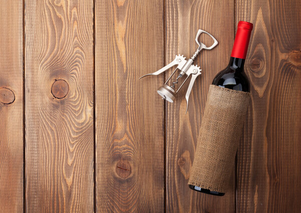 wine bottle and corkscrew on  table
