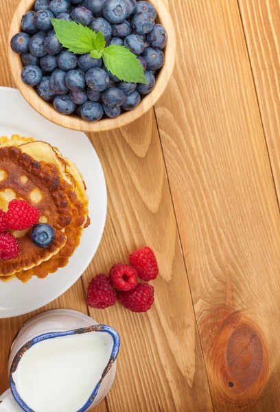 Pancakes with raspberries, blueberries and milk — Stock Photo, Image