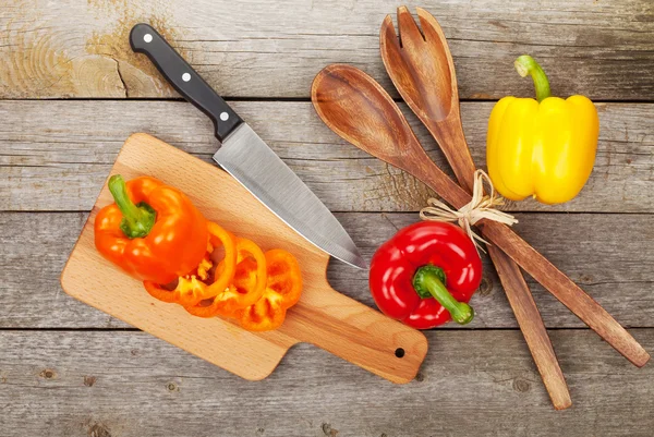 Bell peppers and kitchen utensils — Stock Photo, Image