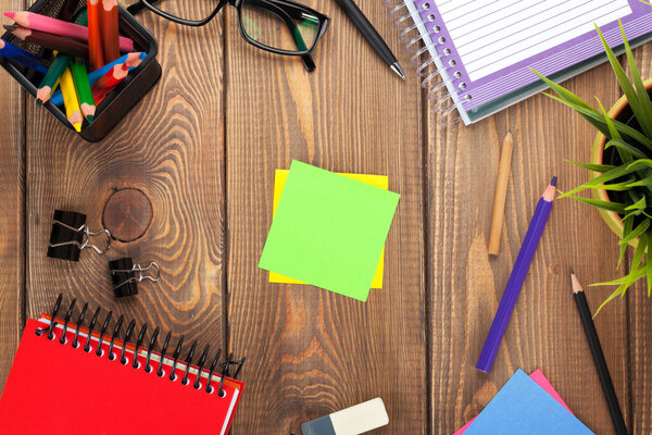 Office table with flowe and blank papers