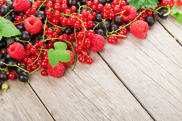 Fresh ripe berries on wooden table — Stock Photo, Image