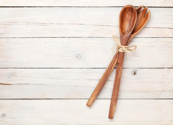 Kitchen utensils over white wooden table — Stock Photo, Image