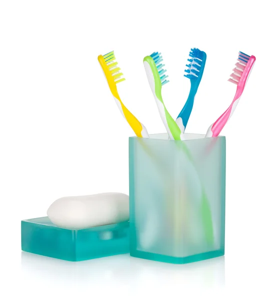 Four   toothbrushes and soap — Stock Photo, Image