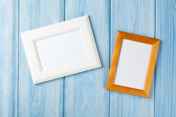 Photo frames on wooden wall — Stock Photo, Image