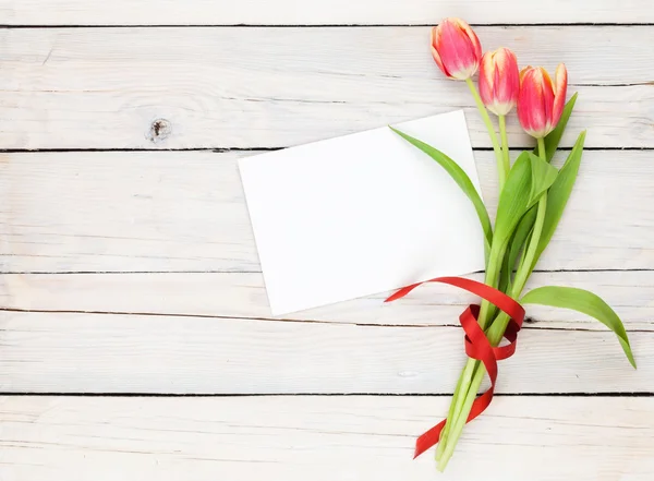 Tulipas coloridas e cartão de saudação — Fotografia de Stock