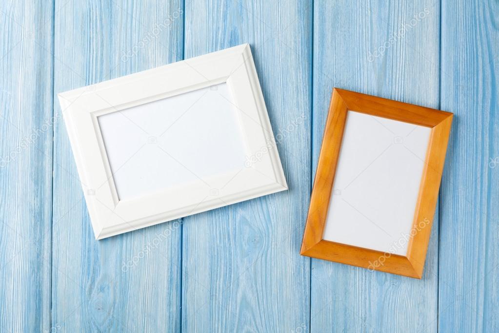 Photo frames on wooden wall