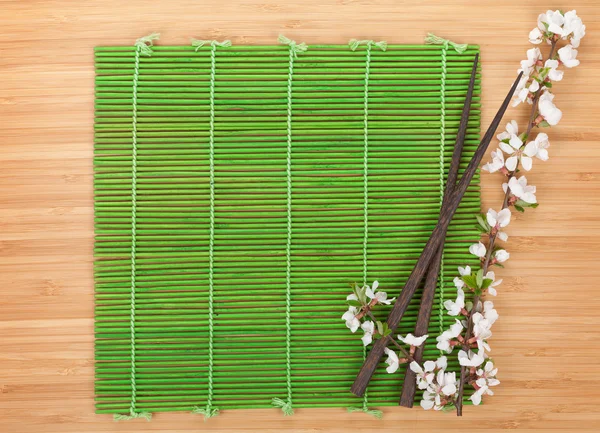 Chopsticks and sakura branch — Stock Photo, Image