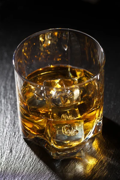 Glass of whiskey with ice — Stock Photo, Image