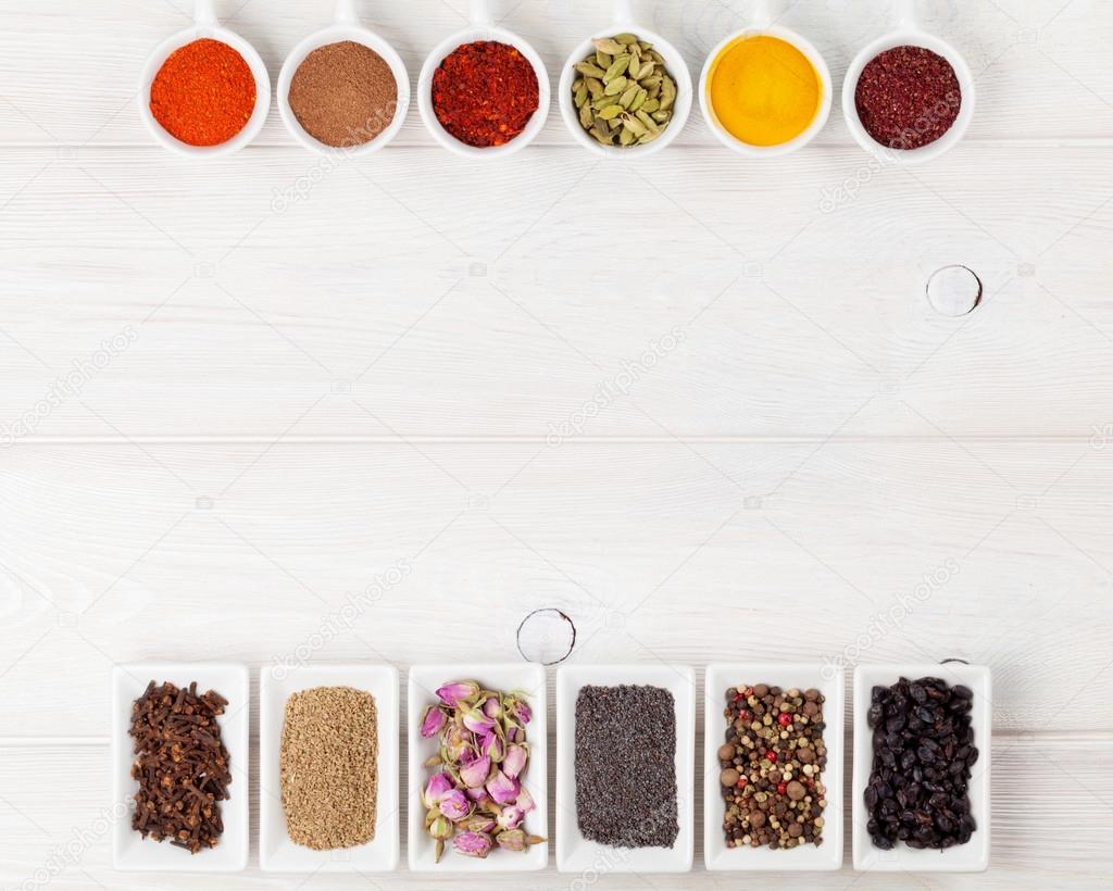 Various spices on white wooden background