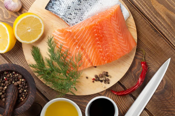 Salmon, spices and condiments — Stock Photo, Image