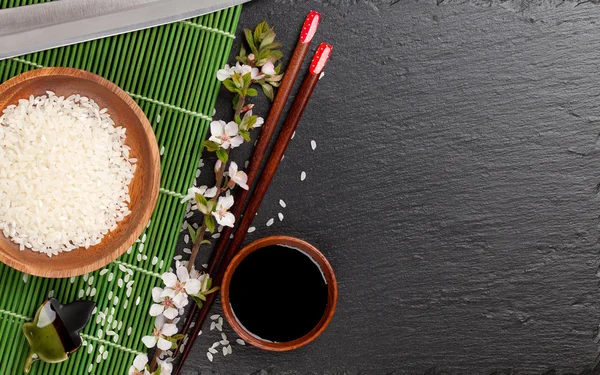 Japanese sushi chopsticks, rice and sakura — Stock Photo, Image