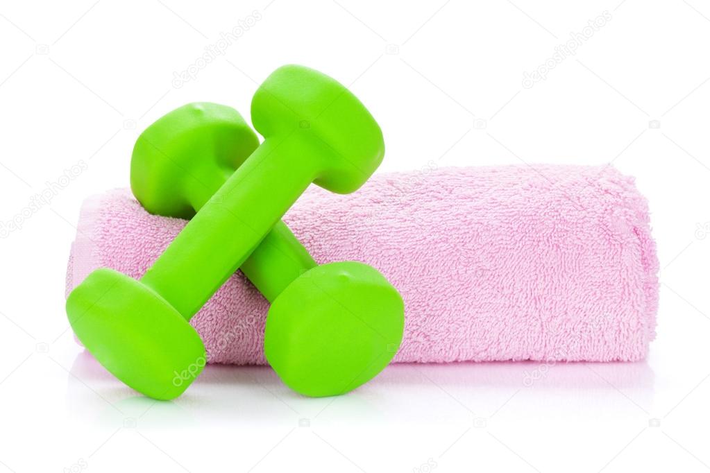 Two green dumbells and towel