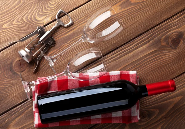 Red wine bottle, glasses and corkscrew — Stock Photo, Image