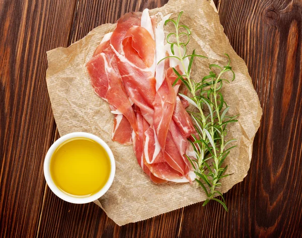 Prosciutto with rosemary and olive oil — Stock Photo, Image